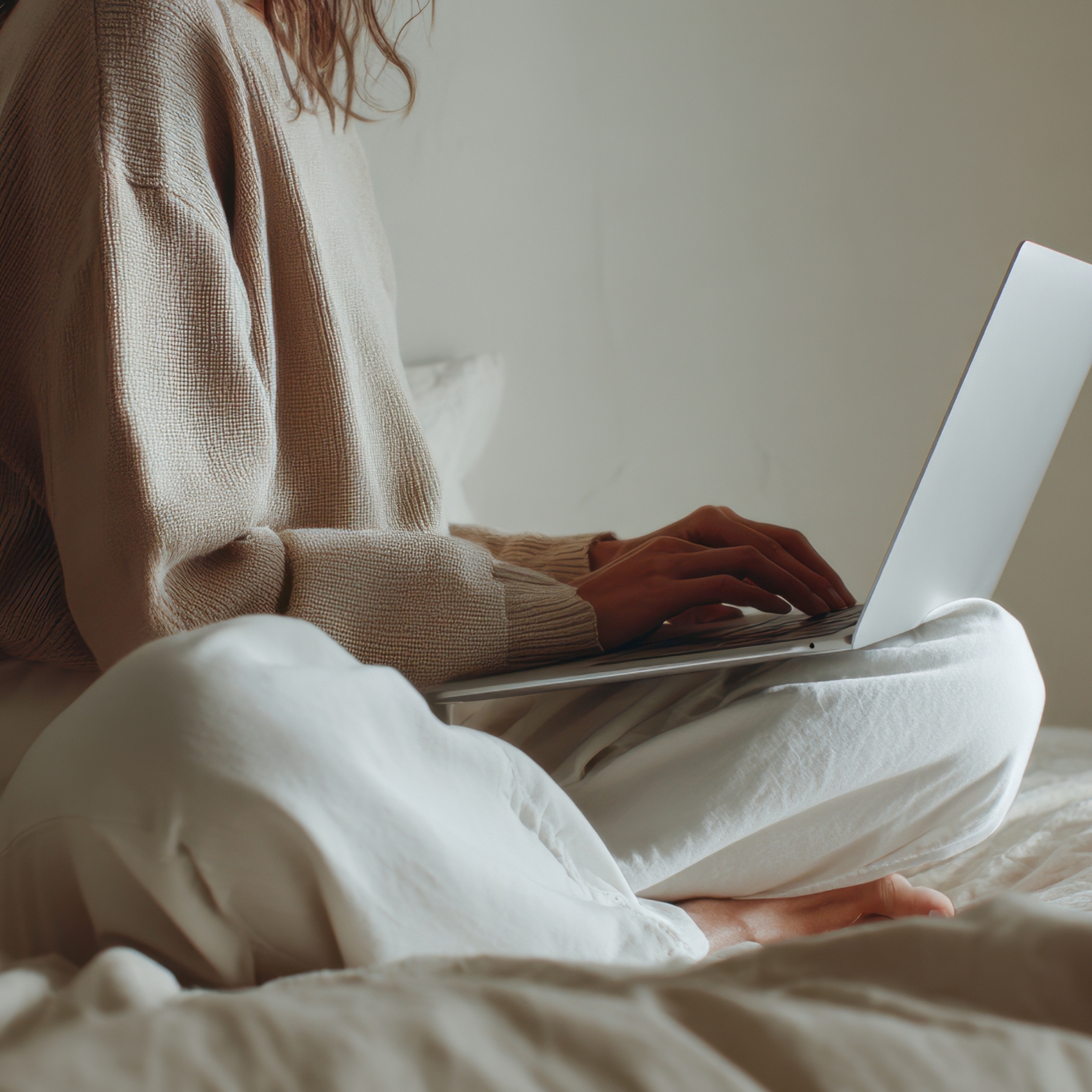 A mother sitting quietly with a laptop, reflecting and working calmly after stepping away from homeschool urgency